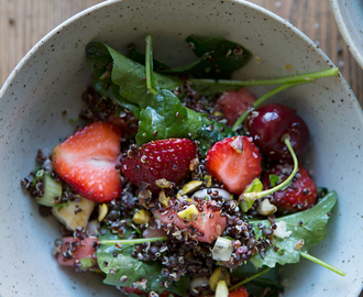 A black quinoa summer salad with baby kale, haloumi, red berries and watermelon