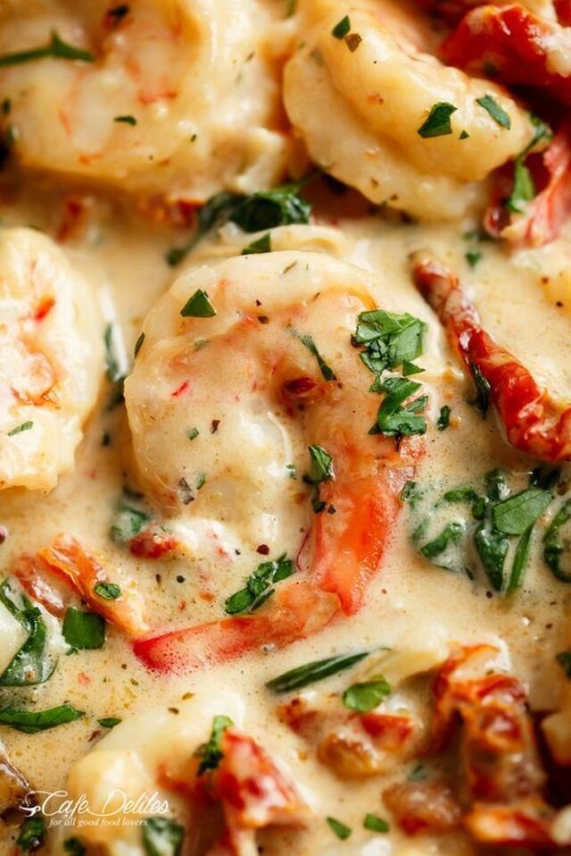 Creamy Garlic Butter Tuscan Shrimp coated in a light and creamy sauce filled with garlic, sun dried tomatoes and spinach! Packed with incred… | Shrimps