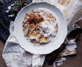 Bounty Porridge with Banana, Grated Dark chocolate, Coconut Cream and Coconut Chips