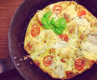 Cheesy omelette with tomato and basil