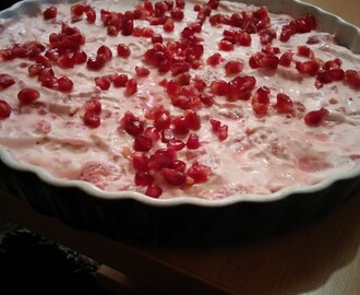 Chocolate cake with strawberry cream and pomegranates