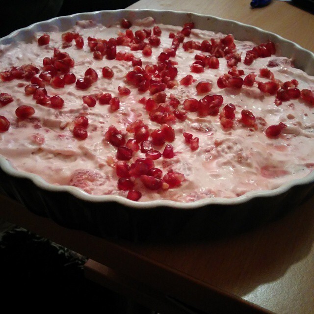 Chocolate cake with strawberry cream and pomegranates