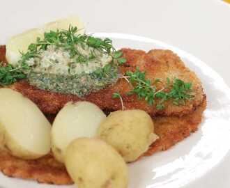 Panerad fläskschnitzel med sardell- och citronsmör