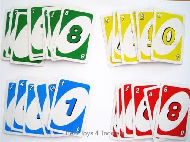 Number and color recognition practice with toddler using uno card game